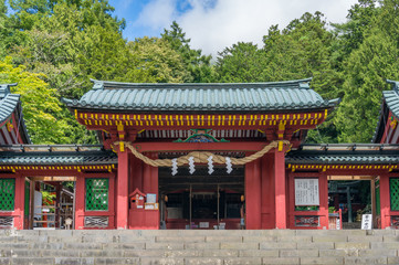 Entrance to Japanese shrine with red decorated gates
