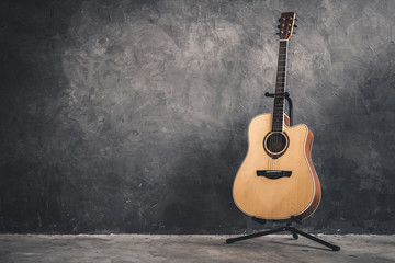 Fototapeta na wymiar acoustic guitar on gray wall background