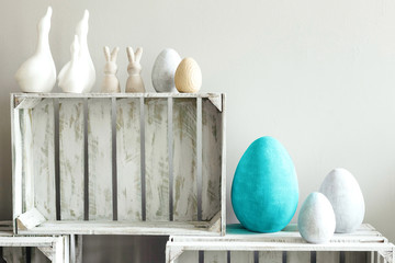 Obraz na płótnie Canvas Bright ceramic egg decor on monochrome gray background. Easter home decor.