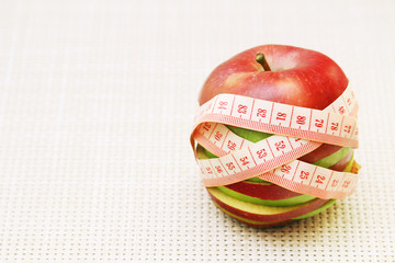 An apple and flexible ruler as a concept of dieting and weight control	