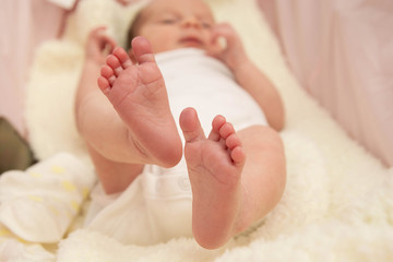 Fototapeta na wymiar A close-up tiny baby feet. Childcare, safety and education concept.