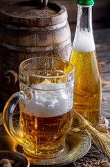 Light beer in a glass on a table in composition with accessories on an old background
