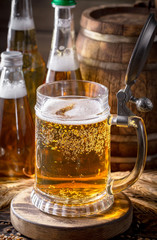 Light beer in a glass, on an old background.