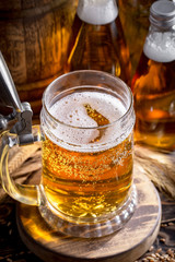 Light beer in a glass on a table in composition with accessories on an old background