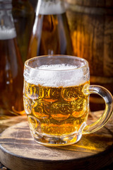 Light beer in a glass on a table in composition with accessories on an old background