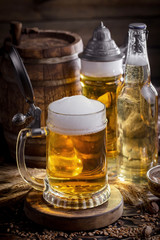 Light beer in a glass, on an old background.