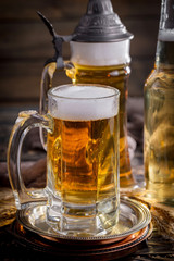 Light beer in a glass on a table in composition with accessories on an old background
