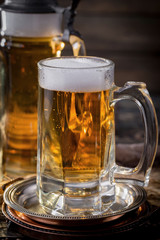 Light beer in a glass, on an old background.