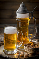 Light beer in a glass, on an old background.