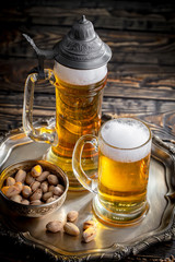 Light beer in a glass on a table in composition with accessories on an old background