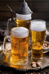 Light beer in a glass on a table in composition with accessories on an old background