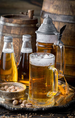 Light frothing beer in a glass, on an old background.