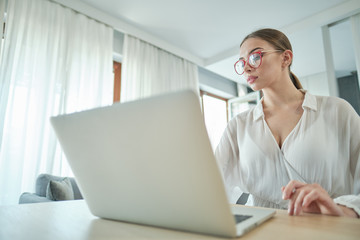 Work during quarantine, a woman at home works on the laptop