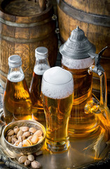 Light frothing beer in a glass, on an old background.