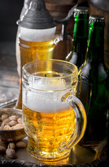 Light beer in a glass on a table in composition with accessories on an old background