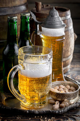 Light beer in a glass on a table in composition with accessories on an old background