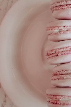 Strawberry french macarons closeup. Fresh and colourful on pink background