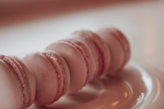 Strawberry french macarons closeup. Fresh and colourful on pink background