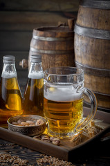 Light beer in a glass on a table in composition with accessories on an old background