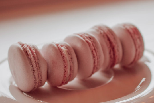 Strawberry french macarons closeup. Fresh and colourful on pink background
