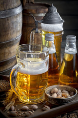 Light frothing beer in a glass, on an old background.