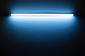 Blue neon lamp on a white wall