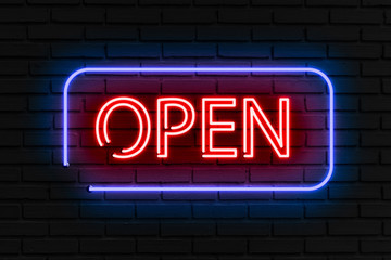 Neon text "open" on the black wall.