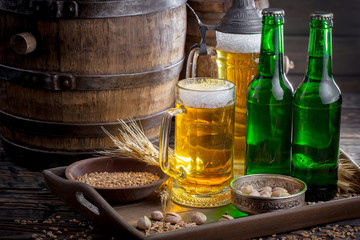 Light beer in a glass on a table in composition with accessories on an old background