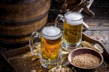 Light beer in a glass, on an old background.