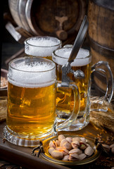 Light beer in a glass, on an old background.