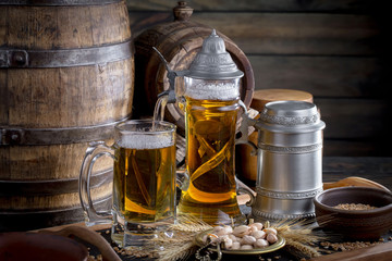 Light frothing beer in a glass, on an old background.