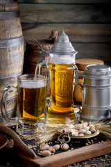 Light beer in a glass on a table in composition with accessories on an old background