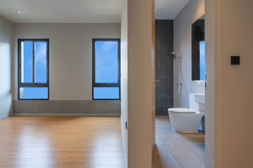 Empty room interior and toilet with windows overlooking the blue sky, Beautiful wooden floor and white wall modern office building or home and living architecture