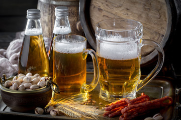 Light frothing beer in a glass, on an old background.