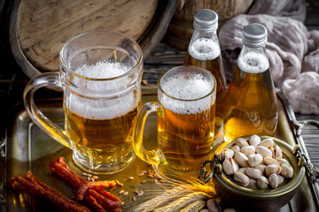 Light beer in a glass on a table in composition with accessories on an old background