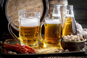 Light beer in a glass on a table in composition with accessories on an old background
