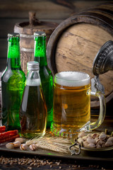 Light beer in a glass on a table in composition with accessories on an old background