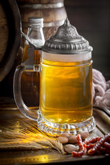 Light beer in a glass on a table in composition with accessories on an old background