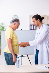 Fototapeta premium Doctor dietician giving advices to fat overweight patient