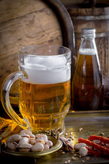 Light beer in a glass on a table in composition with accessories on an old background
