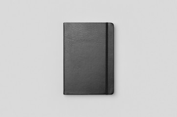 Black notebook mockup on a grey background. Frontside.