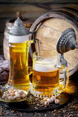 Light beer in a glass on a table in composition with accessories on an old background