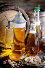 Light beer in a glass on a table in composition with accessories on an old background