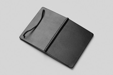 Black notebook outside mockup on a grey background.