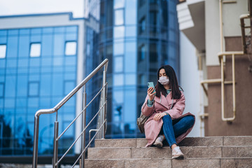 Female in medical protective mask outdoors in the empty city. Health protection and prevention of virus outbreak, coronavirus, COVID-19, epidemic and pandemic, quarantine concept