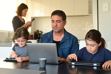 Family at home as the pandemic coronavirus (COVID-19) forces many employees and students to work...