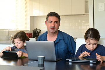 Upset displaced father forced to work from home as the pandemic coronavirus (COVID-19) forces many...