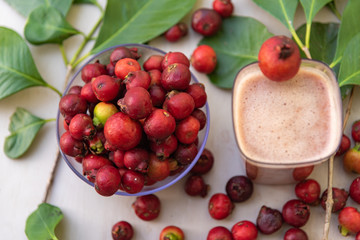 Glass of juice and fruits of red aracá (Psidium cattleyanum Sabine) in natura