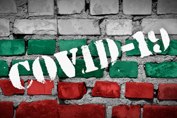 Flag of Bulgaria on the brick wall with sprayed stencil COVID-19 on it. 2019 - 2020 Novel Coronavirus (2019-nCoV) concept, for an outbreak occurs in Bulgaria.