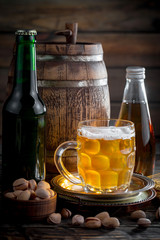Light beer in a glass, on an old background.